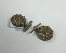 A pair of silver filigree cufflinks of circular fo