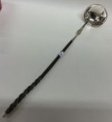 An 18th Century silver bright cut toddy ladle with