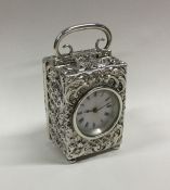 A good silver embossed carriage clock with scroll