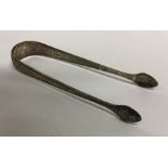 A pair of bright cut silver sugar tongs. London. A