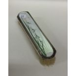 An attractive silver and enamelled brush with lily