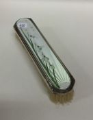 An attractive silver and enamelled brush with lily