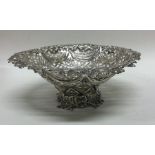 A large circular silver bonbon dish with floral de