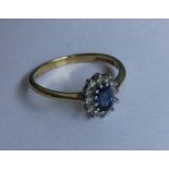 An oval diamond cluster ring in two colour claw mo