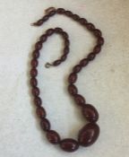 A tapering string of red amber beads. 43 grams. Es