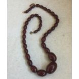 A tapering string of red amber beads. 43 grams. Es