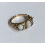 An opal and diamond seven stone ring in carved mou