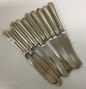 A set of ten silver mounted dessert knives. Approx