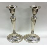 A pair of Edwardian silver candlesticks of taperin