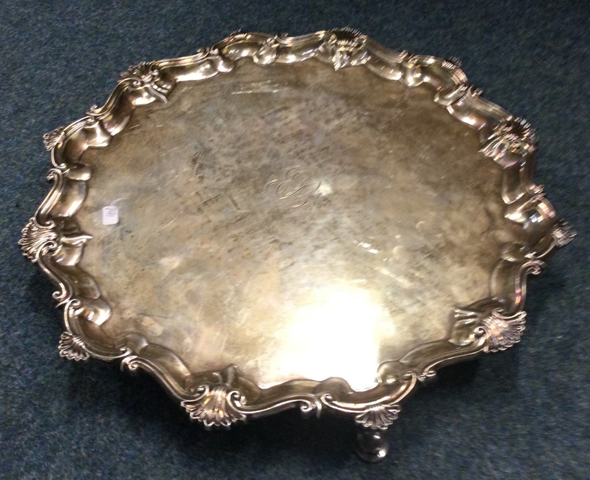 A large Georgian silver salver with shell border.