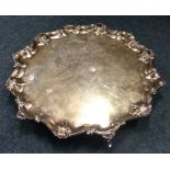 A large Georgian silver salver with shell border.