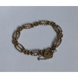 A 9 carat fancy link gate bracelet with heart shap