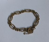 A 9 carat fancy link gate bracelet with heart shap