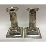 A pair of Edwardian silver candlesticks with flute