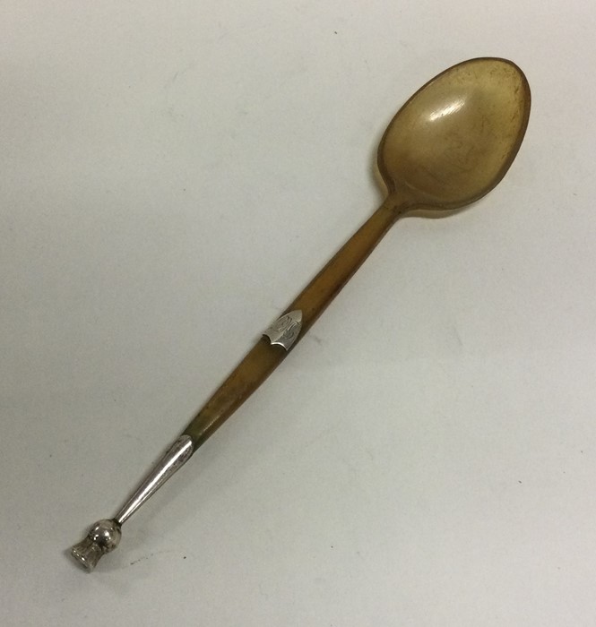 A horn and silver mounted spoon in the form of a t