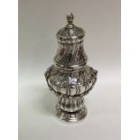 A Continental silver sugar caster with fluted deco