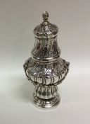 A Continental silver sugar caster with fluted deco