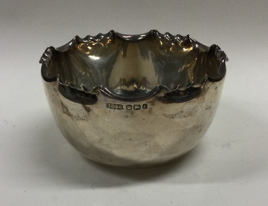 An Edwardian silver sugar bowl with shaped edge. S