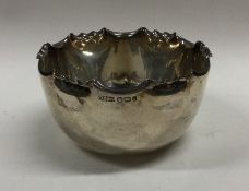 An Edwardian silver sugar bowl with shaped edge. S