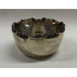 An Edwardian silver sugar bowl with shaped edge. S