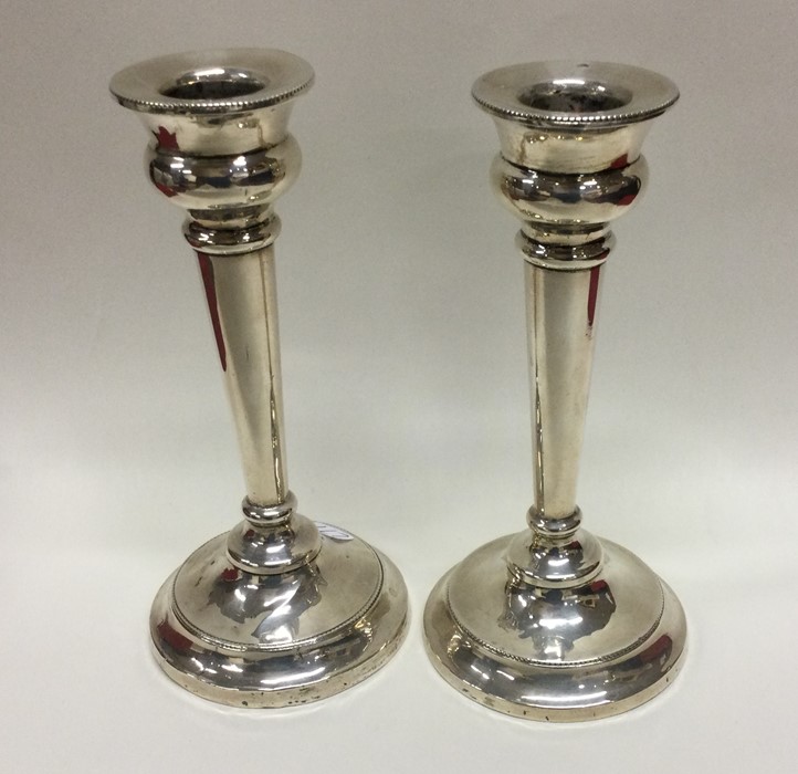 A pair of circular silver candlesticks. Birmingham