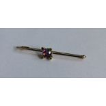 An amethyst and gold bar brooch in claw mount. App