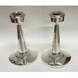 A pair of Edwardian tapering silver candlesticks.