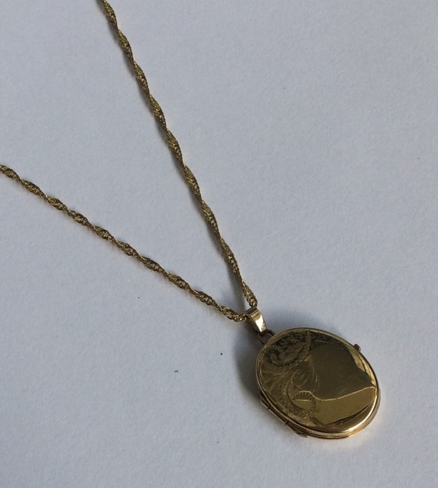 A lady's 9 carat oval locket on fine link chain. A