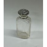 A silver mounted glass scent bottle embossed with