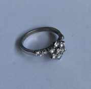 A good diamond daisy head cluster ring in 18 carat
