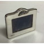 A small rectangular silver picture frame with scro
