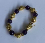 A stylish amethyst and high carat gold bracelet wi
