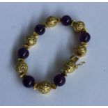 A stylish amethyst and high carat gold bracelet wi