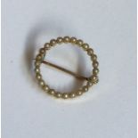 A circular seed pearl brooch set in gold. Approx.