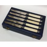 A cased set of twelve silver and ivory knives with