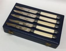 A cased set of twelve silver and ivory knives with