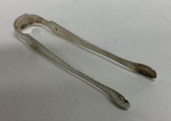 A pair of shaped Georgian silver sugar tongs. Lond