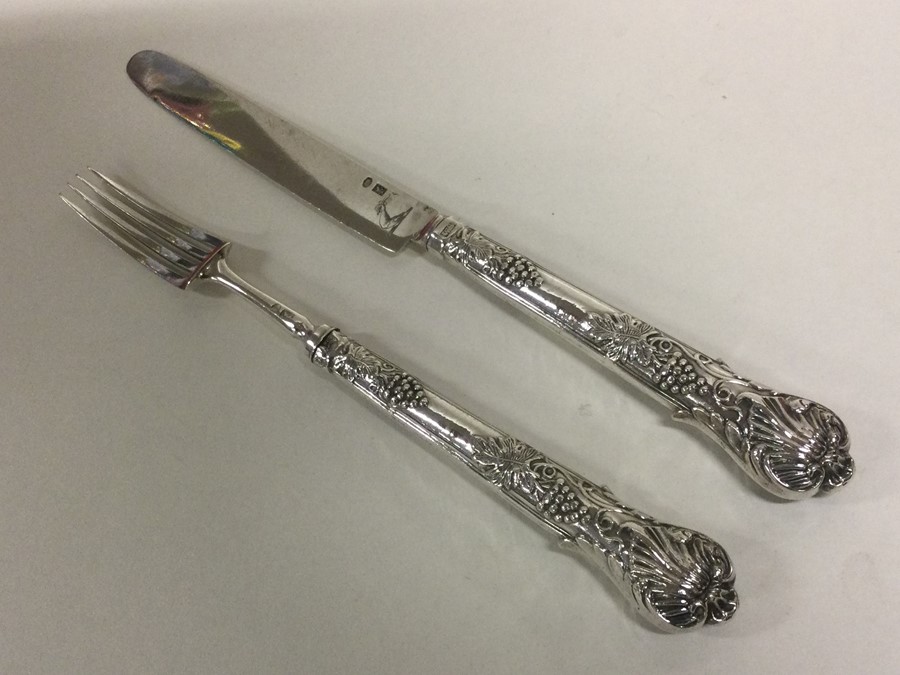 A silver mounted and crested fruit knife and fork