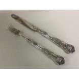 A silver mounted and crested fruit knife and fork