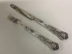 A silver mounted and crested fruit knife and fork