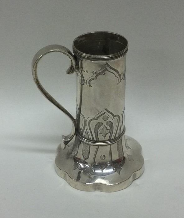 A novelty tapering silver mug with engraved decora