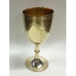 A large silver gilt engraved goblet on spreading b