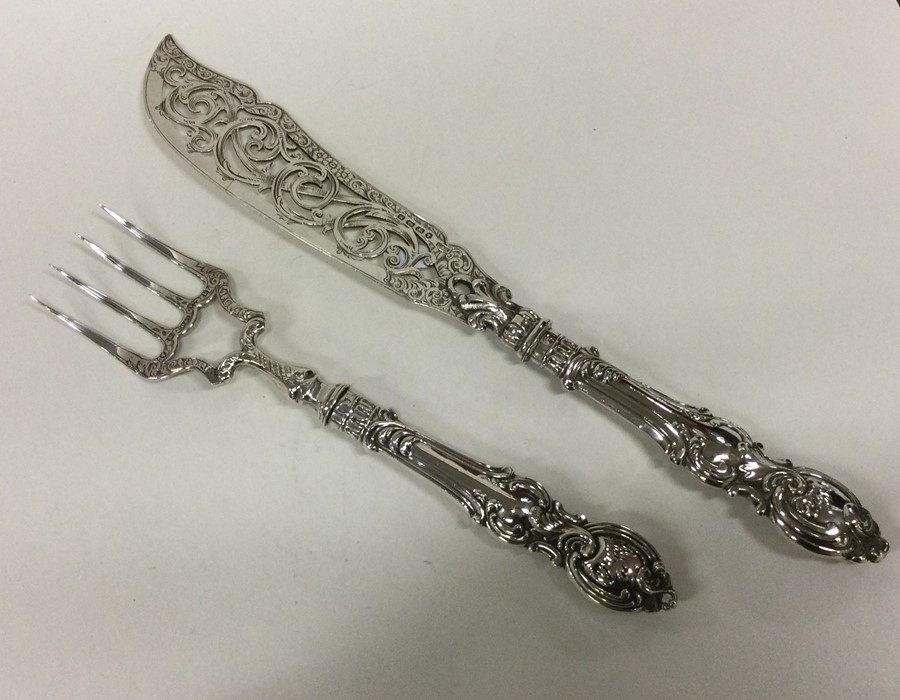 A large pair of silver fish servers with chased ha