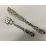 A large pair of silver fish servers with chased ha