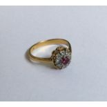 A stylish ruby and diamond circular cluster ring i