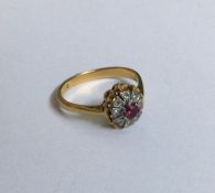 A stylish ruby and diamond circular cluster ring i