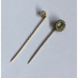 An Antique pearl mounted stick pin in gold togethe