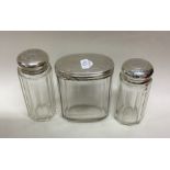 A group of three silver mounted dressing table jar