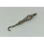 A miniature silver embossed button hook with loop