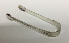 A pair of George III silver bright cut sugar tongs